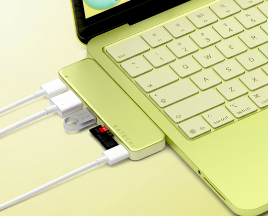 Satechi MacBook Neo accessories: USB-C hub, travel adapter, and wireless mouse in Citrus